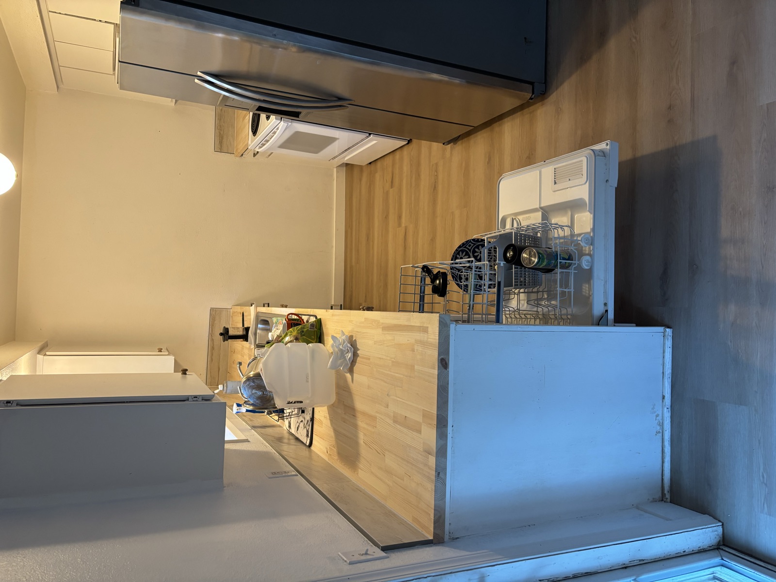 316 Noel Ave kitchen after — new butcher-block counters, wide-plank floor, and appliances