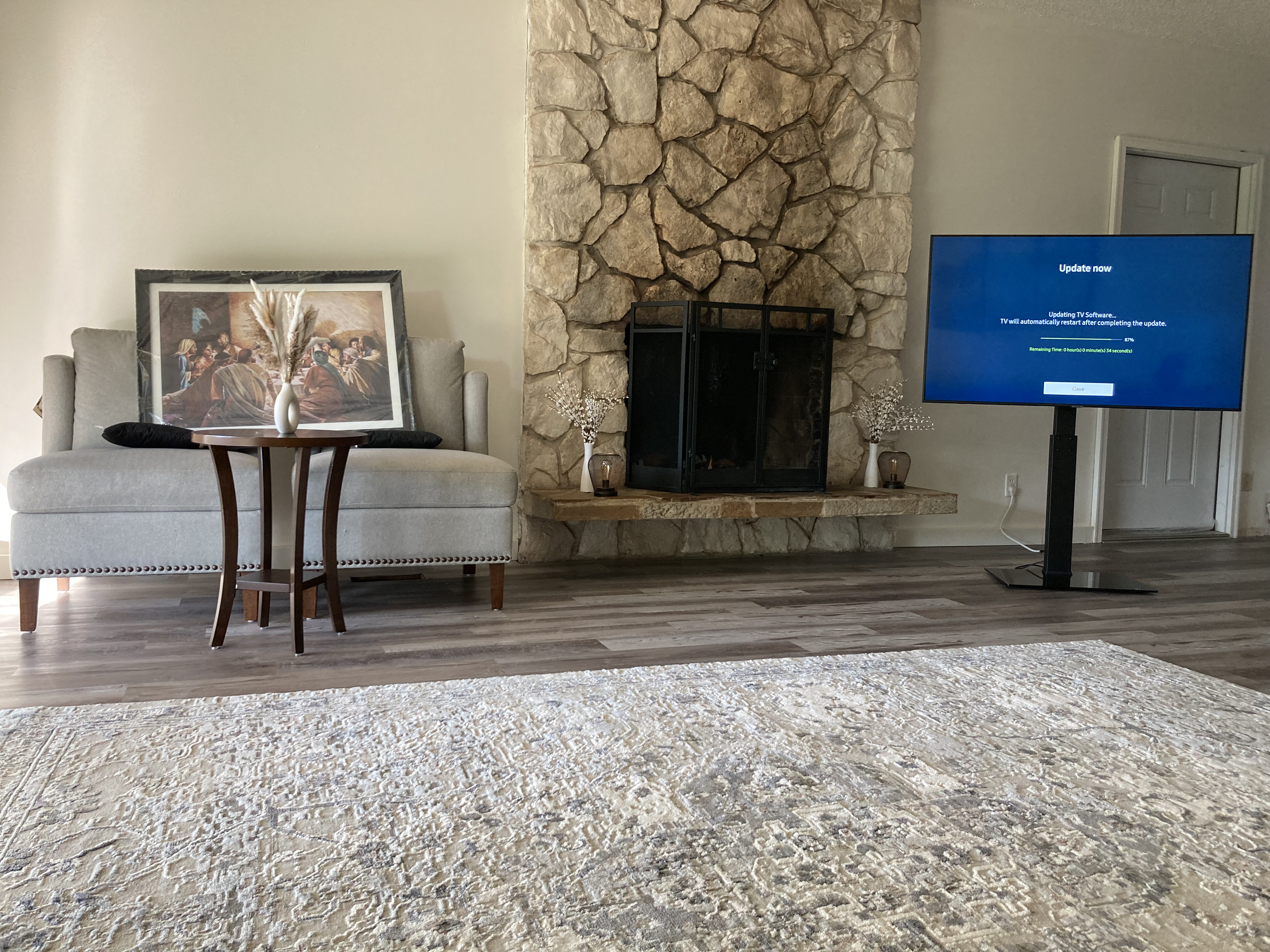 3017 Galvin Road Unit A living room, after renovation — new plank flooring, staged and furnished